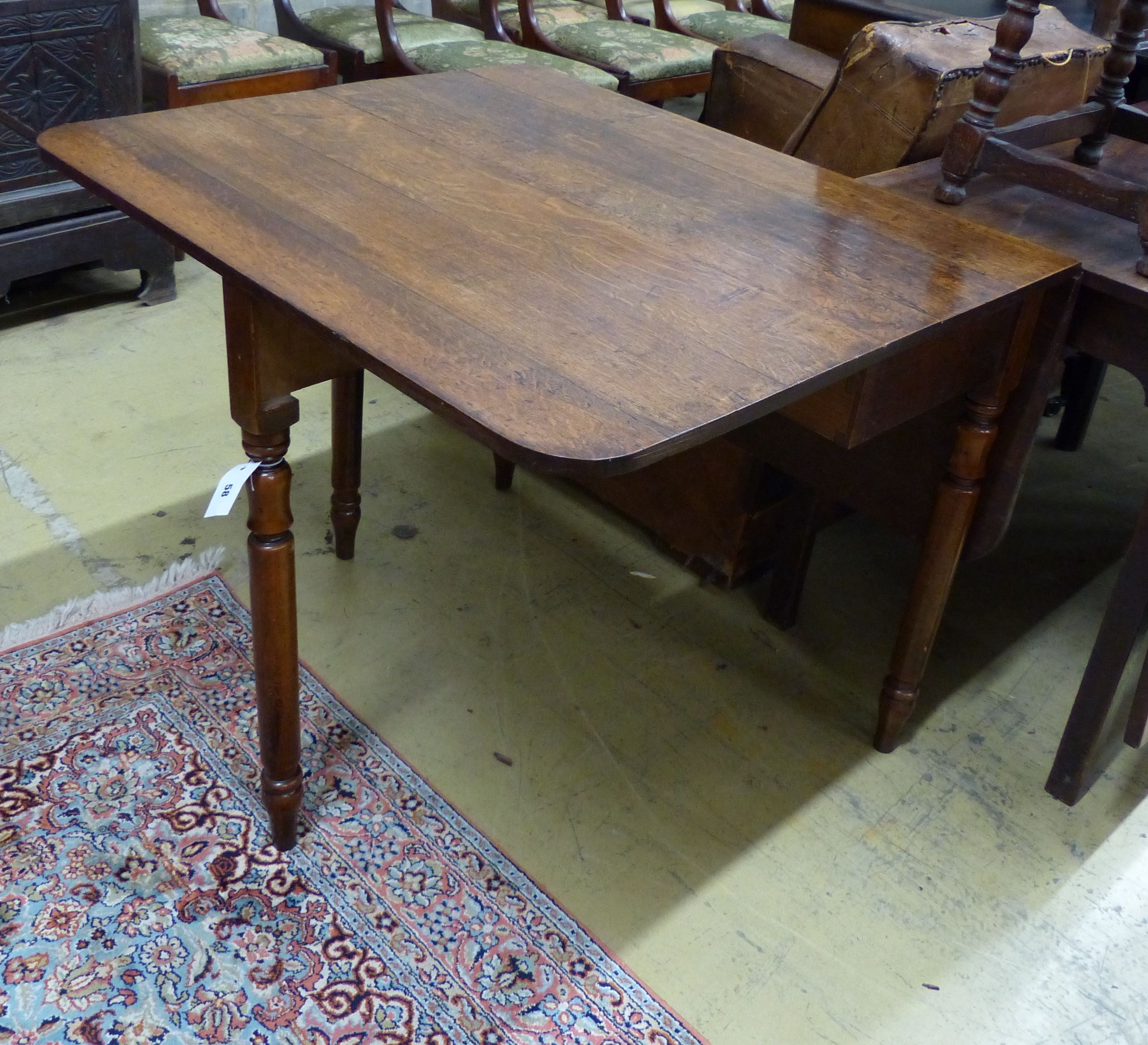An early Victorian oak drop leaf dining table, length 90cm